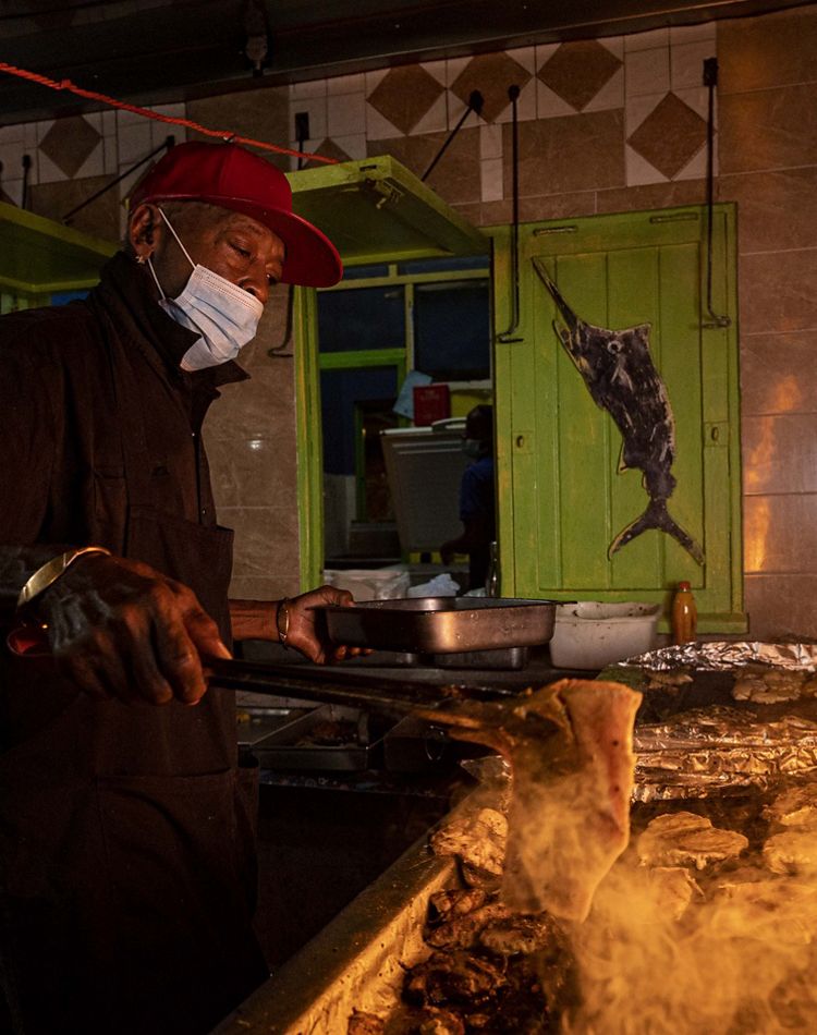 Photo of flames coming off a grill for cooking fish.
