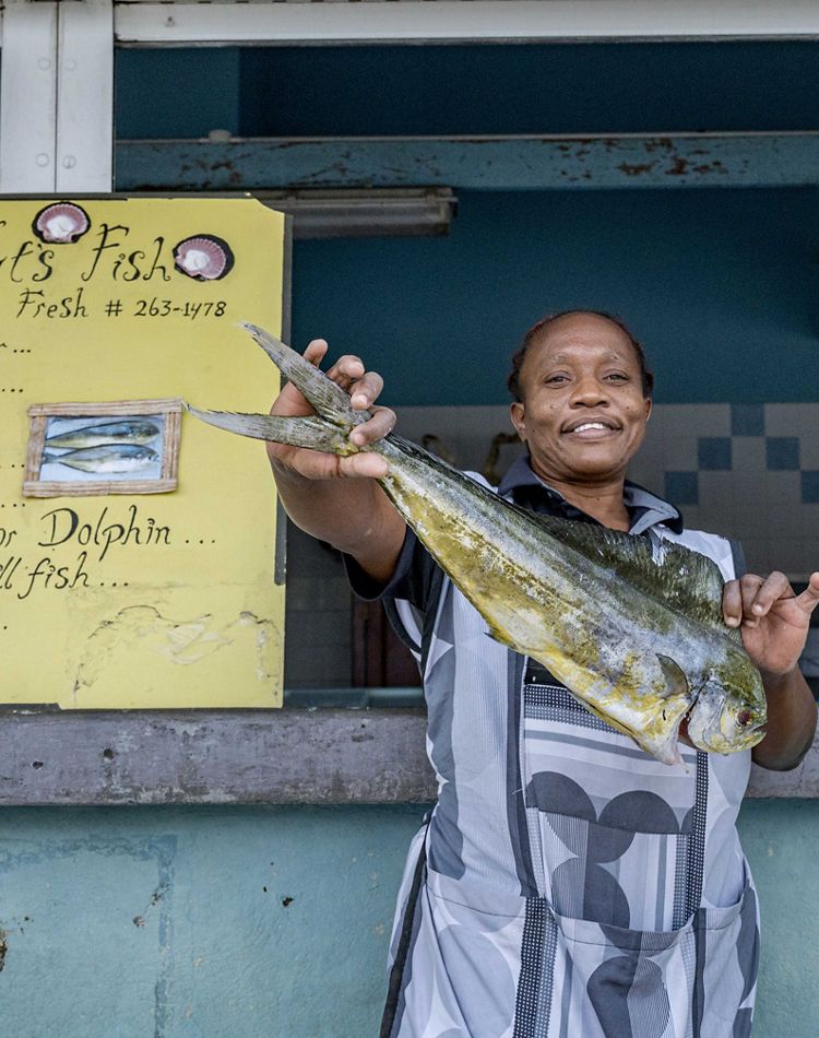 Photo of a woman named Natalie standing by a menu.