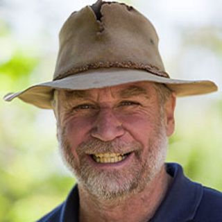 Headshot of Boze Hancock, bearded and smiling, wearing wide brim hat.