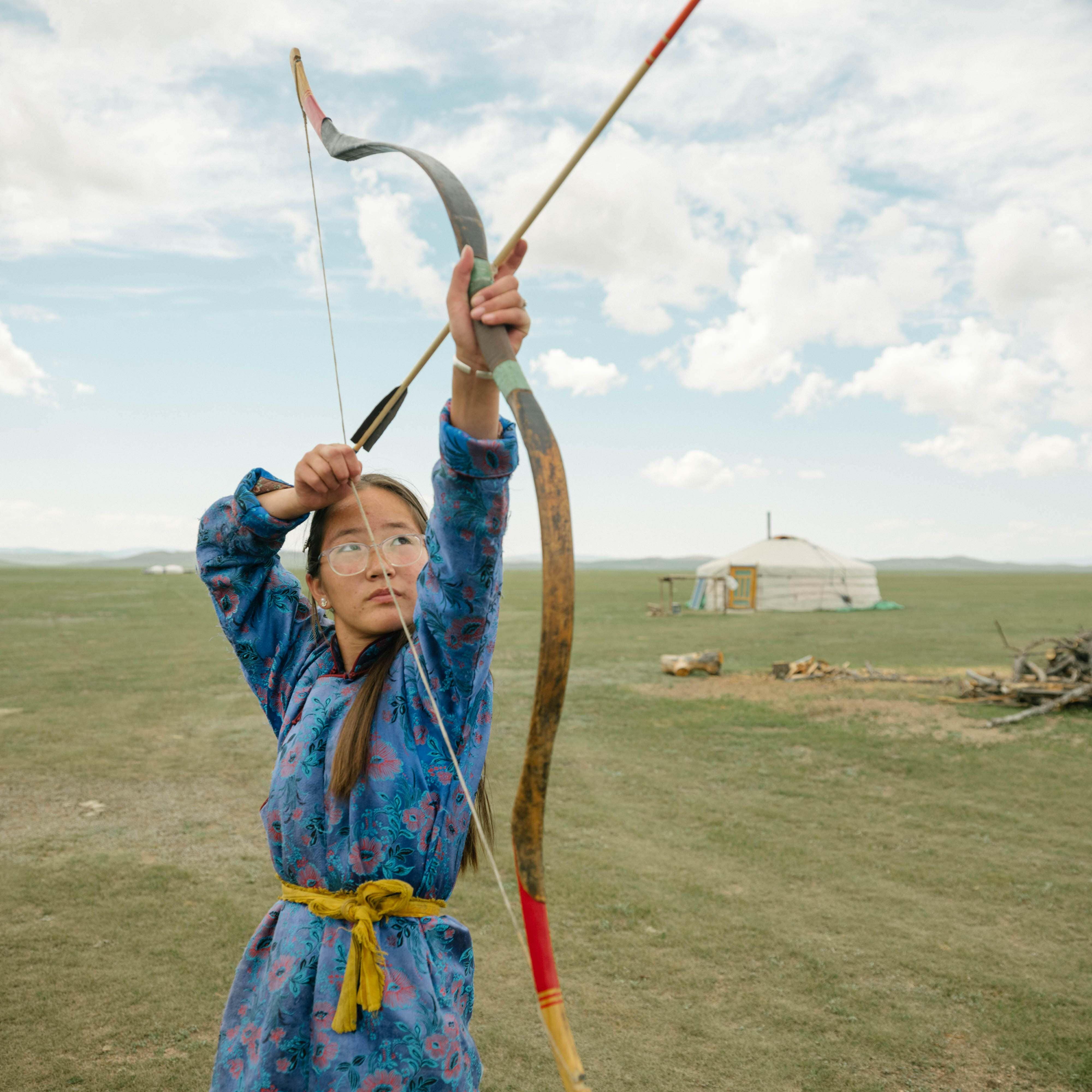 A person holding a bow and arrow.