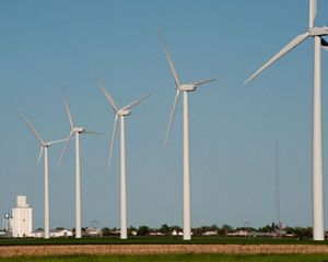 A row of turbines tower over the flat landscape at a wind facility in Kansas.
